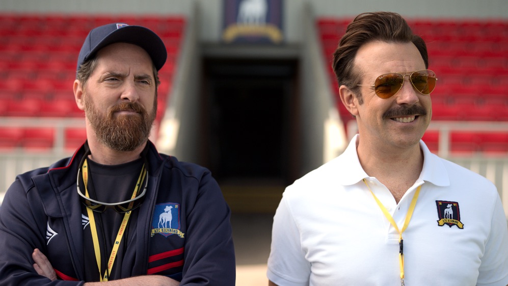 Brendan Hunt e Jason Sudeikis in Ted Lasso 1x02 'Biscuits' [tag: Brendan Hunt, Jason Sudeikis] [credit: courtesy of Apple TV Plus]