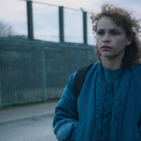 Iola Evans come Kayla in Choose or Die